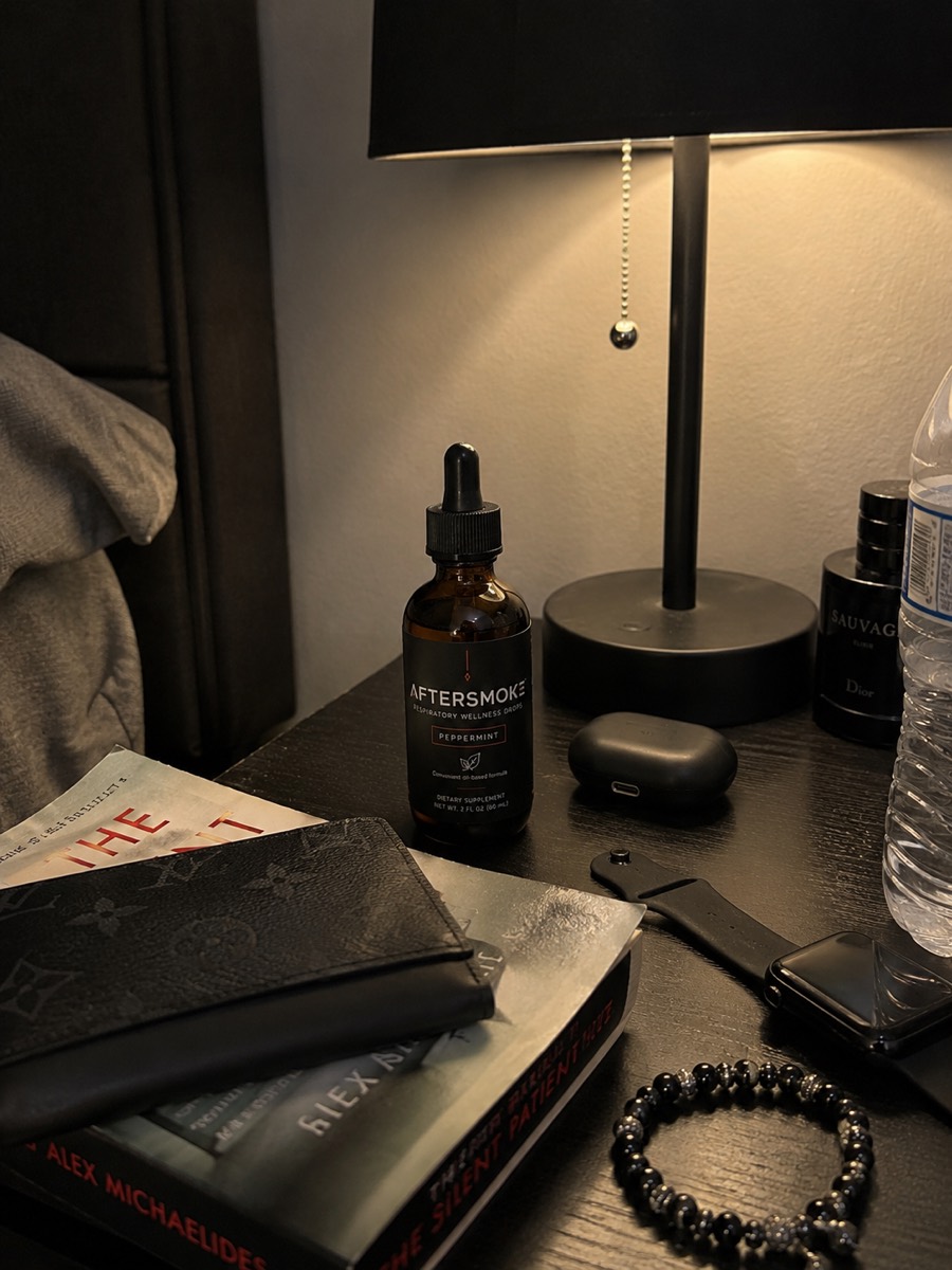 AfterSmoke bottle on a nightstand under a lamp